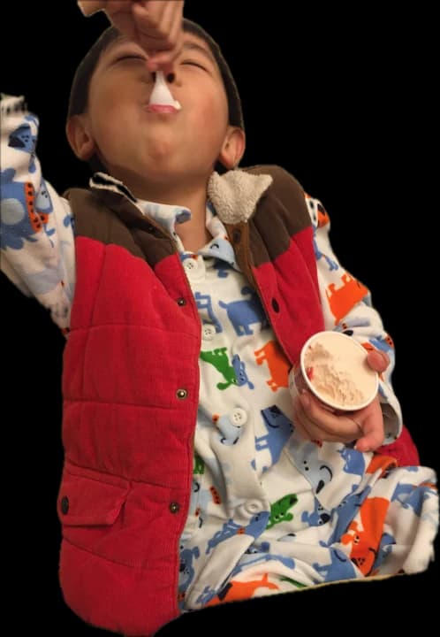 Little me in a red vest, eating ice cream off the spoon