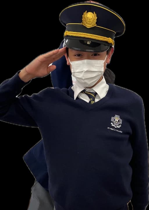 Me saluting in a borrowed police cap at school