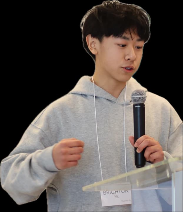 Me speaking at a pitch event in a gray hoodie