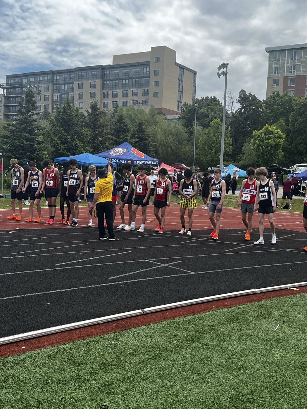 Runners lined up on the start line of an outdoor track race