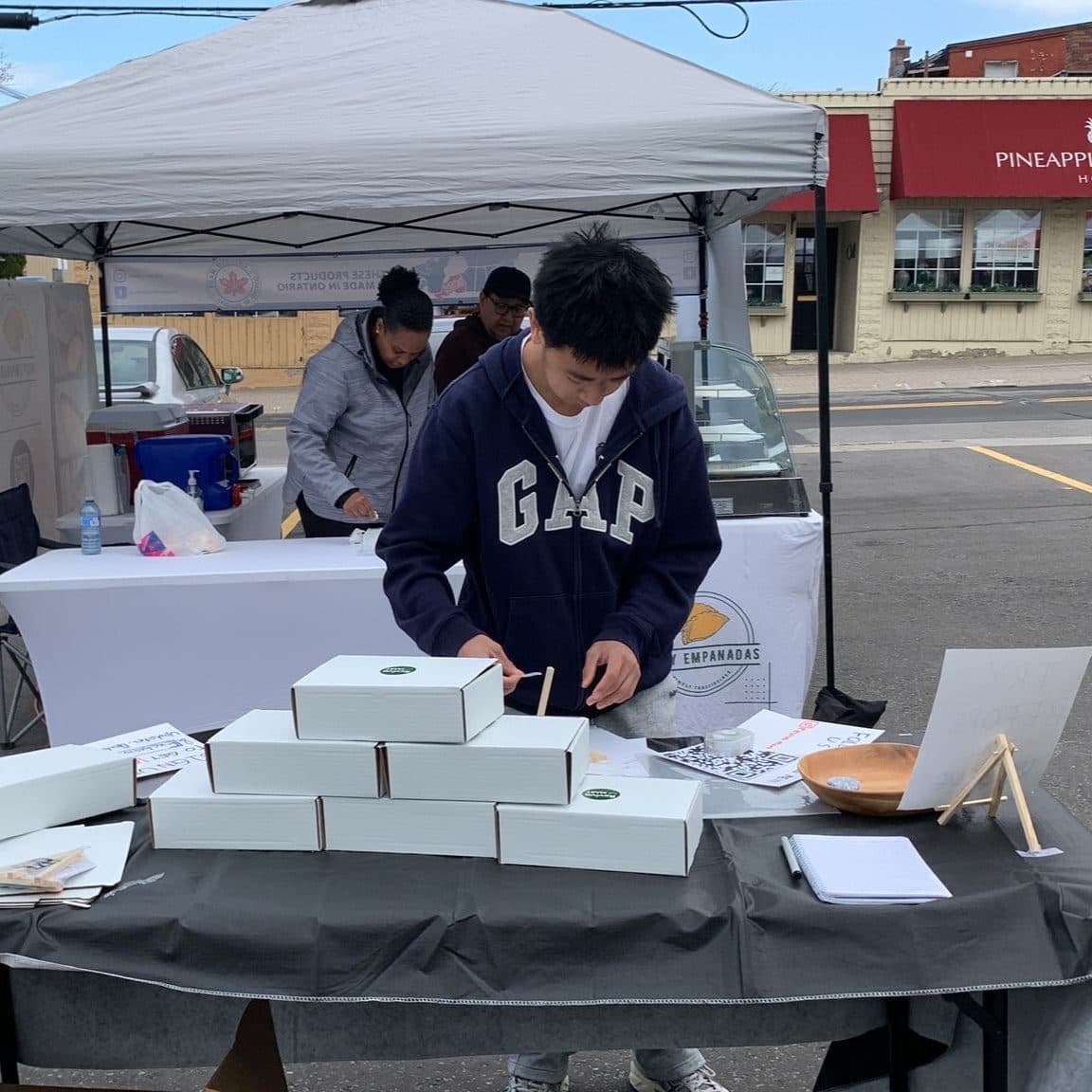 Packing Reviva Mart boxes at a farmers market